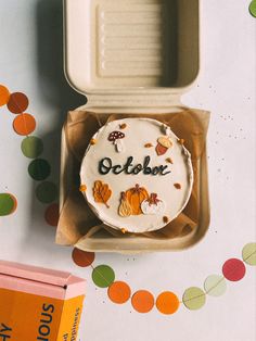 a cake in a box with the word october written on it