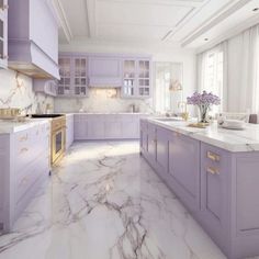 a large kitchen with marble counter tops and purple cabinetry, along with white walls