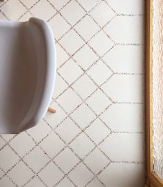 a white urinal mounted to the side of a wall