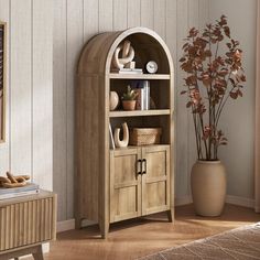 a room with a wooden bookcase and potted plant in the corner next to it