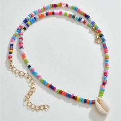 This Colorful Beaded Cowrie Puka Seashell Necklace Is A Wonderful Addition To Your Wardrobe And Your Style! A Fun And Unique Piece! Shell-shaped Beaded Necklaces For Beach Season, Colorful Beaded Shell Necklaces For Vacation, Colorful Beads Shell Strand Necklace, Colorful Beaded Shell-shaped Necklace For Beach, Beach Shell Necklaces With Colorful Beads, Beach Shell-shaped Beaded Necklaces, Multicolor Shell-shaped Jewelry For Beach, Multicolor Beaded Necklaces For Beach Season, Colorful Round Beads Beach Necklace