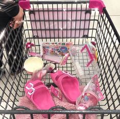 a shopping cart filled with pink shoes and other items