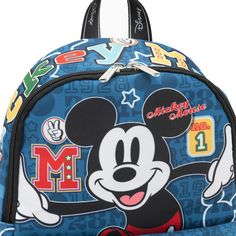 Take your stuff with you with this colorful nylon backpack by WondaPop featuring the Walt Disney's classic Mickey Mouse born October 1, 1928. Mickey looks happy on the front of the bag with No. 1 and Mickey symbols on the front pocket. "Mickey Mouse" is boldly displayed across the top of the bag. The day pack is covered with No. 1 and 1928 and it has two side pockets. The back of the bag shows Mickey looking very proud. The pack features a huge main compartment with two zipper pulls, two side po Mickey Mouse Standard Backpack For Disney Trips, Mickey Mouse Themed Backpack For Disney Trips, Disney Mickey Mouse Backpack, Back To School Backpack For Disney Fan Events, Casual Backpack With Character Print For Back To School, Casual Character Print Backpack For Back To School, Disney Mickey Mouse Backpack For School, Disney Mickey Mouse Standard Backpack, Mickey Mouse Backpack For School