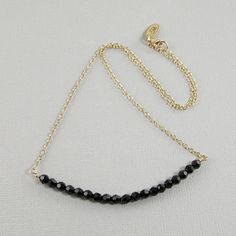 This Swarovski crystal necklace is stylish and classy. Made with 4mm black Swarovski crystals and 14k gold filled chain with a 14k gold filled lobster clasp. Versatile piece that can be worn to the office or with that little black dress. Available in five necklace lengths. Please choose the length you want from the drop-down menu.The necklace will arrive in an attractive gift box. Elegant Black Single Strand Crystal Necklace, Black Necklace With Delicate Chain For Party, Black Delicate Chain Necklace For Party, Faceted Black Spinel Necklace, Black Faceted Crystal Necklace Elegant Style, Black Delicate Chain Necklace For Formal Occasions, Black Formal Necklace With Delicate Chain, Elegant Black Faceted Crystal Necklace, Minimalist Black Faceted Jewelry