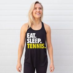 This flowy tennis tank top has a bold "Eat. Sleep. Tennis." design that's sure to be a favorite hot weather top and a great gift for any tennis player.  The super soft and lightweight racerback tank top is the perfect choice for spring and summer activities and will be a go-to wardrobe staple for any dedicated tennis player, who will wear this stylish tank top all the time to  proudly show off their love for the sport. Available in a selection of colors, and featuring a fashionable, slight high- Tennis Design, Tennis Apparel, Tennis Tank Tops, Stylish Tank Tops, Tennis Player, Tennis Clothes, Bold Black, Tennis Players, Eat Sleep