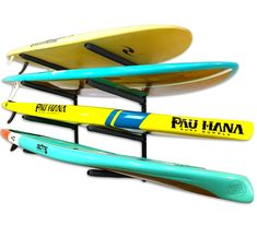 three surfboards and two paddles on a rack