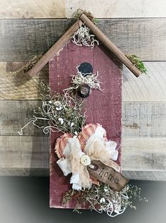 a birdhouse made out of wood and fabric