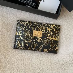 Authentic Kept Unused Black & Gold W/ Aged Gold Hardware Include: Box, Dustbag, Carebooklet & Authenticity Card (Shown In Last Photo) Rare & Highly Sought After | Each Piece Has Its Own Unique Print Patterns ~ All Sales Are Final. Ig: Cloudsh.Luxury Please Feel Free To Msg Me If You Have Any Questions! Thank You! Designer Gold Bifold Wallet, Designer Gold Wallet With Card Slots, Designer Gold Wallets With Card Slots, Gold Wallets With Original Box For Gift, Chanel Graffiti, Chanel Accessories, Key Card Holder, Chanel Shoes, Real Pictures