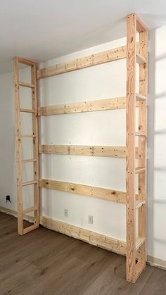 an empty room with some wooden shelves in it