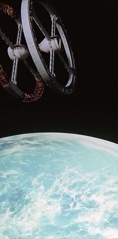 an artist's rendering of a space station flying over the earth in outer space