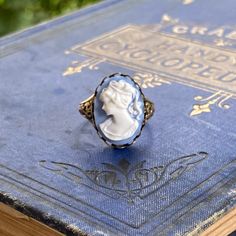 18x13mm blue and white acrylic lady cameo.On an antiqued sterling silver plated or antiqued brass cigar band style ring. Easy to adjust to most sizes. Cameo Ring, White Acrylic, White Acrylics, Antique Brass, Women Rings, Antique Silver, Silver Plate, Silver Plated, Rings For Men