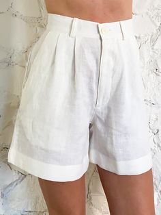 This classic double-pleated high-waisted short can be worn long or rolled up. It has one back pocket. This is a pure ivory linen. All our fabrics are upcycled deadstock. Dry-clean only, if you want them to remain exactly the same. You can wash them, even dry them if you want. But they will get smaller, softer, wrinklier and lighter. High Waist Linen Shorts, Tailored Linen Shorts, High Waisted Linen Shorts, Long Linen Shorts Outfit, Linen Skirt Short, Long Tailored Shorts, Long Linen Shorts, Linen Fashion Women Summer, How To Style Linen Shorts