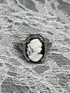 Cameo Ring  Edward Design#70 Made To Order Here we have an Edwardian reproduction ring in sterling silver filigree with a black and white cameo that details a classic lady silhouette. This beautiful cameo measures 14mm in length and 10mm in width. This ring also sits 7mm off the finger. The inside of the band is marked 925 for solid sterling. Notice the beautiful leaf and floral design of the filigree setting and etched band. This is a lovely rendition of an Antique filigree ring.  This amazing Adjustable Gothic Rings, Engraved Heirloom Rings, Antique Silver Nickel-free Rings, Vintage Sterling Silver Engraved Ring, Handmade Victorian Style Rings, Black Round Cameo Jewelry, Gothic Silver Filigree Ring For Gifts, Nickel-free Silver Engraved Ring, Victorian Rings Stamped 925