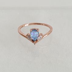 Dainty Rose Gold Plated Blue Opal (Simulated) Ring. Features An Pear Shaped Blue Opal, Surrounded By Smaller, White/Clear Stones. Item Is A Size 6, New, And Unworn. Please Be Certain To Look At All The Photos Carefully, And Ask Any Questions You May Have Prior To Making A Purchase. Opalescent Sapphire Ring, Opalescent Sapphire, Dainty Rose, Blue Opal Ring, Clear Stone, Blue Plates, I Love Jewelry, Opal Ring, Blue Opal