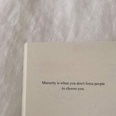 a book that is laying on top of a white sheet with the words mauriry is when you don't force people to choose to choose to choose you