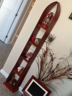 a tall wooden shelf sitting next to a white door