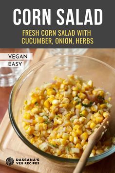 corn salad in a glass bowl with a wooden spoon