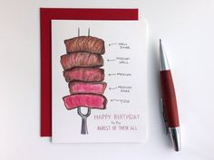 a card with a drawing of a stack of meat on it and a pen next to it