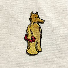 a yellow dog with a red bag on it's back