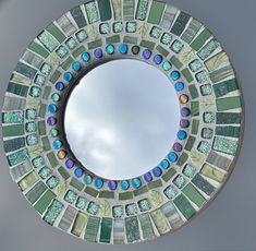 there is a circular mirror made out of mosaic tiles