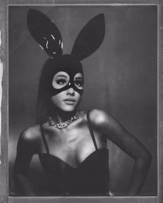 a woman wearing a bunny mask with her hands on her hips