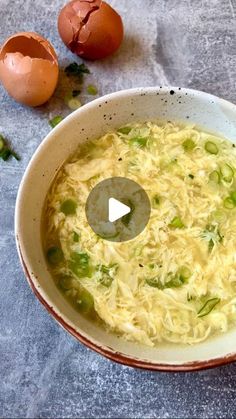 a bowl filled with soup next to an egg