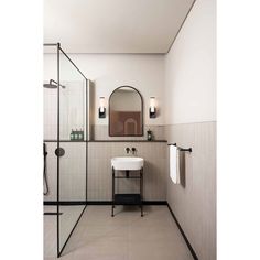 a white sink sitting under a mirror in a bathroom next to a walk in shower