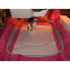 the sewing machine is being used to sew something on it's surface,