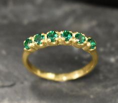 Half Eternity Ring set with a Create Emerald in a flawless diamond cut, clarity & color, 3mm each (1 Carat all), Band width 2mm. Gold Eternity Ring design - Gold Vermeil: 18k Gold Plating on Solid 925 Sterling Silver. Click here for ☞ Matching Pendant ☞ Choose your size ☞ I resize (before shipping) for FREE to Any size* Details : ♥ Each item comes in a cute GIFT BOX ✓ ♥ GUARANTEE on the materials ✓ ♥ Created Emerald - diamond cut, flawless clarity & deep green color ✓ ♥ Pure Solid 925 Sterling Silver ☞ Silver Hallmark on each piece ♕ ♥ The ring is plated with 14K Gold (the thickest plating - 3 Micron) ✓ ♥ Measurements: Emerald size 3 millimetres diameter, 1 Carats all ✓ ♥ Band Width 2mm, Thickness 0.9mm ✓ ♥ Each stone is set professionally - Real Jewelry artisan work ♕ ♥ More Beautiful jew Elegant Green Stackable Rings With Half Eternity, Elegant Green Stackable Half Eternity Rings, Classic Green Stackable Rings For May Birthstone, Green Half Eternity Stackable Rings Fine Jewelry, Fine Jewelry Green Stackable Rings With Prong Setting, Classic Green Stackable Rings With Prong Setting, Classic Green Emerald Cut Stackable Rings, Classic Green Emerald Stackable Rings, Classic Green Emerald-cut Stackable Rings