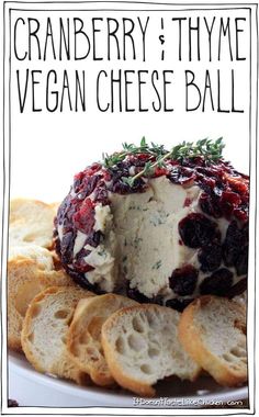 cranberry and thyme vegan cheese ball on a plate with crackers