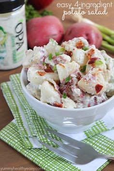 a white bowl filled with potato salad next to some radishes