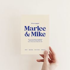 a person holding up a card with the words marbee and mike printed on it