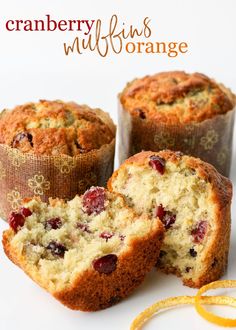 three muffins with cranberries and raisins in them on a white surface