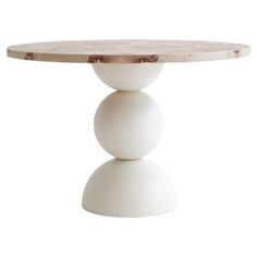 a round table with three white balls on the top and one in the middle, against a white background