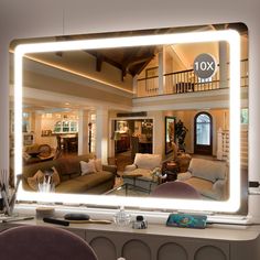 a large mirror reflecting the inside of a living room with couches and chairs in it