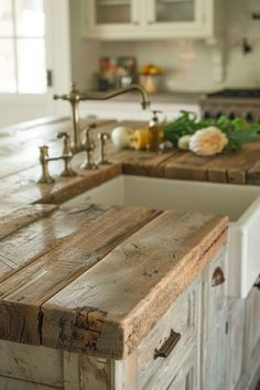 a kitchen counter made out of wooden planks with an island in the middle and sink on one side