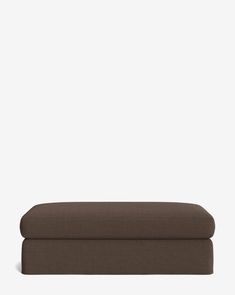 a brown ottoman sitting on top of a white floor