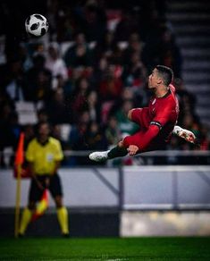 a soccer player in the air catching a ball