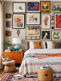 a bedroom with pictures on the wall above the bed