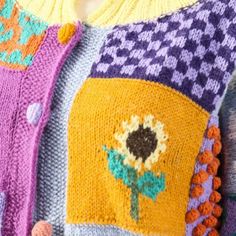 the sweaters are knitted with flowers and buttons on them, but not in color