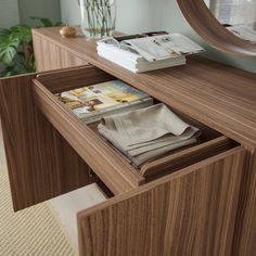 a wooden dresser with magazines in it