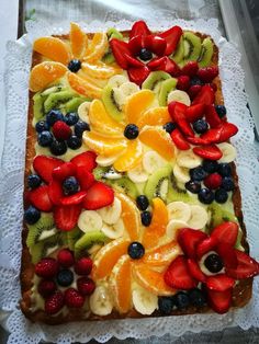 a square cake with fruit on top of it