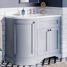 a bathroom with a sink, mirror and rug on the floor in front of it