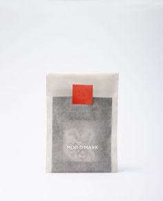 a bag with a red sticker on it sitting in front of a white background