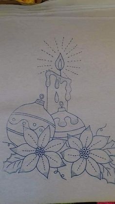 a drawing of a candle and flowers on a piece of white paper with blue ink