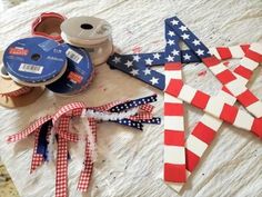 several patriotic items are laid out on a table to be used as decorations for the fourth of july