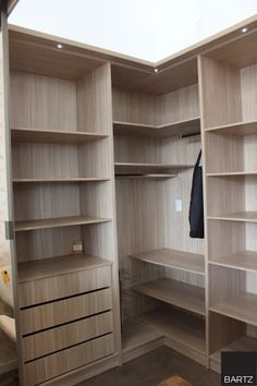 an empty walk in closet with shelves and drawers