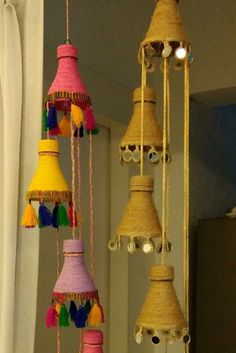 several different types of bells hanging from the ceiling