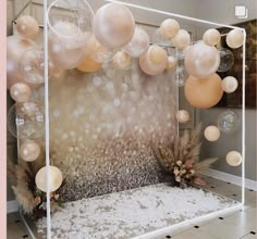 a room with balloons and decorations on the wall in front of an open area for people to sit down