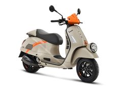 a white scooter with an orange seat on the front and back tire rims